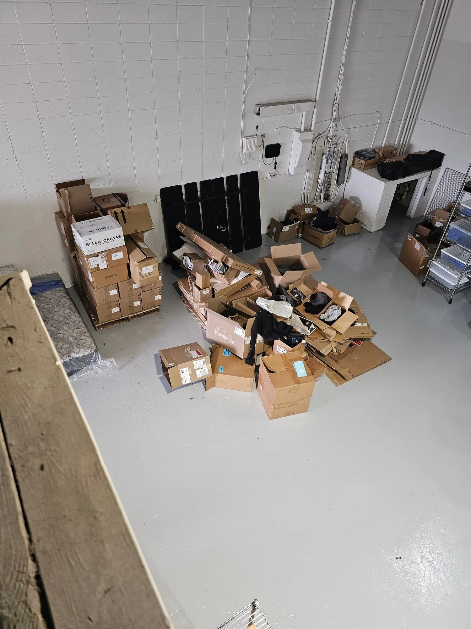 Commercial warehouse floor stacked with boxes and pallets before a cleanout