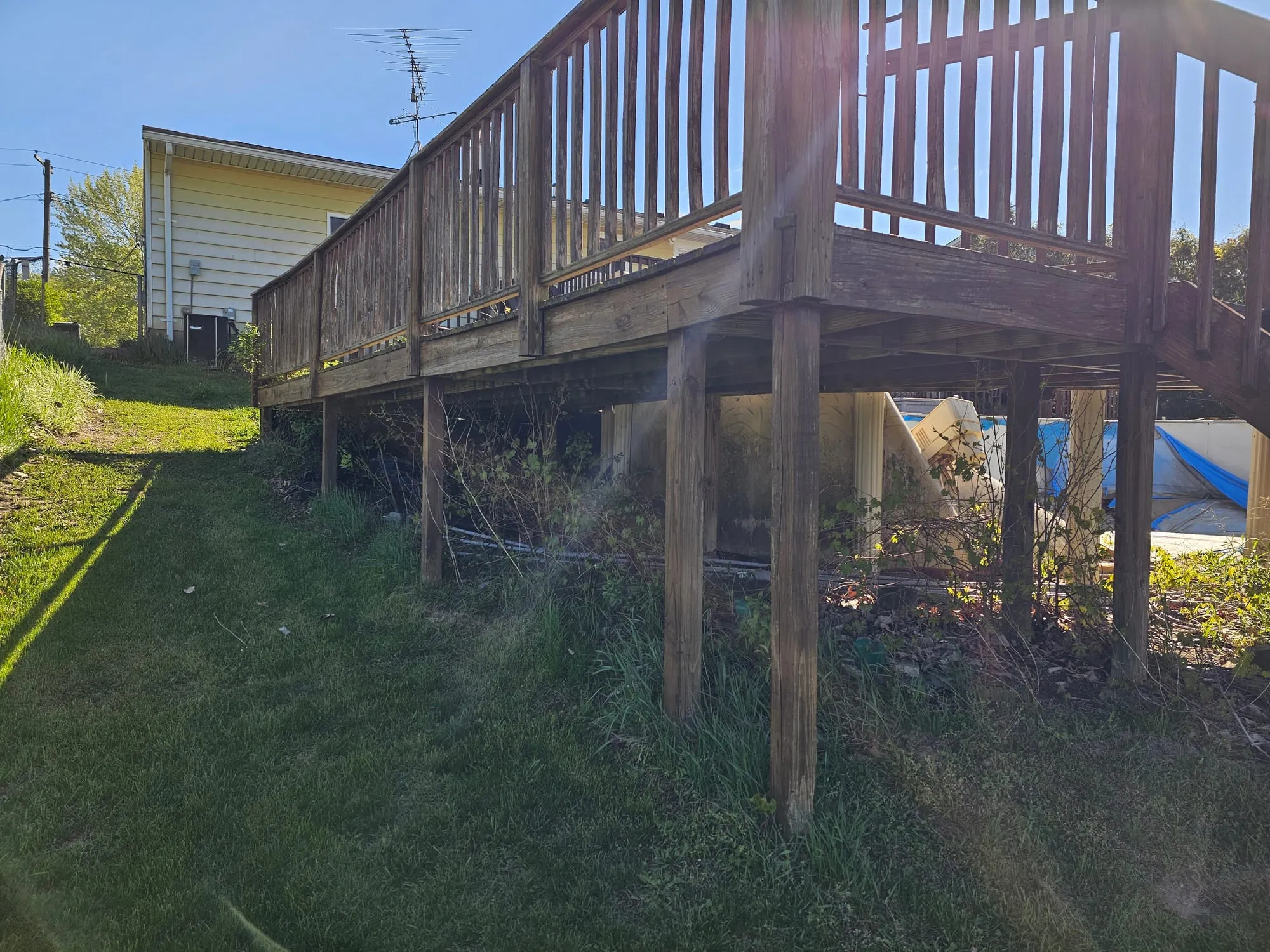 Deck framing and posts exposed during a Metro Detroit deck teardown