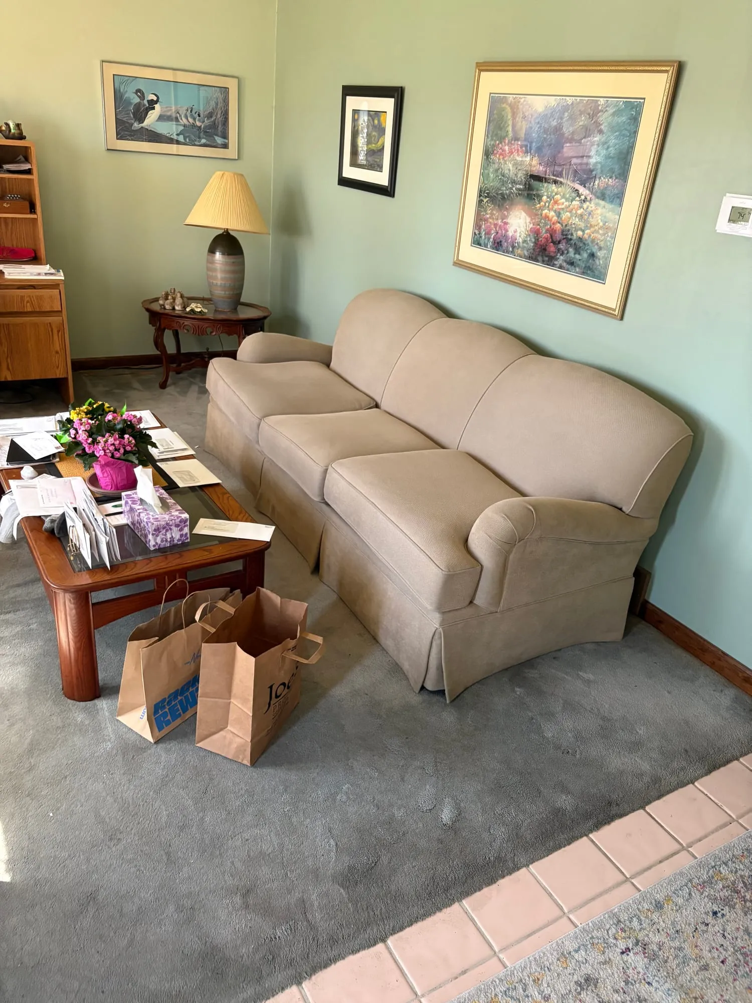 Furnished living room with couch, coffee table and lamps before an estate cleanout