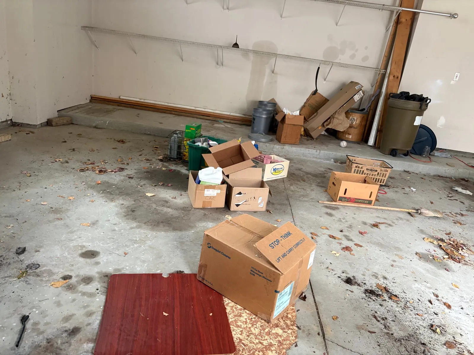 Garage filled with stacked boxes and household debris