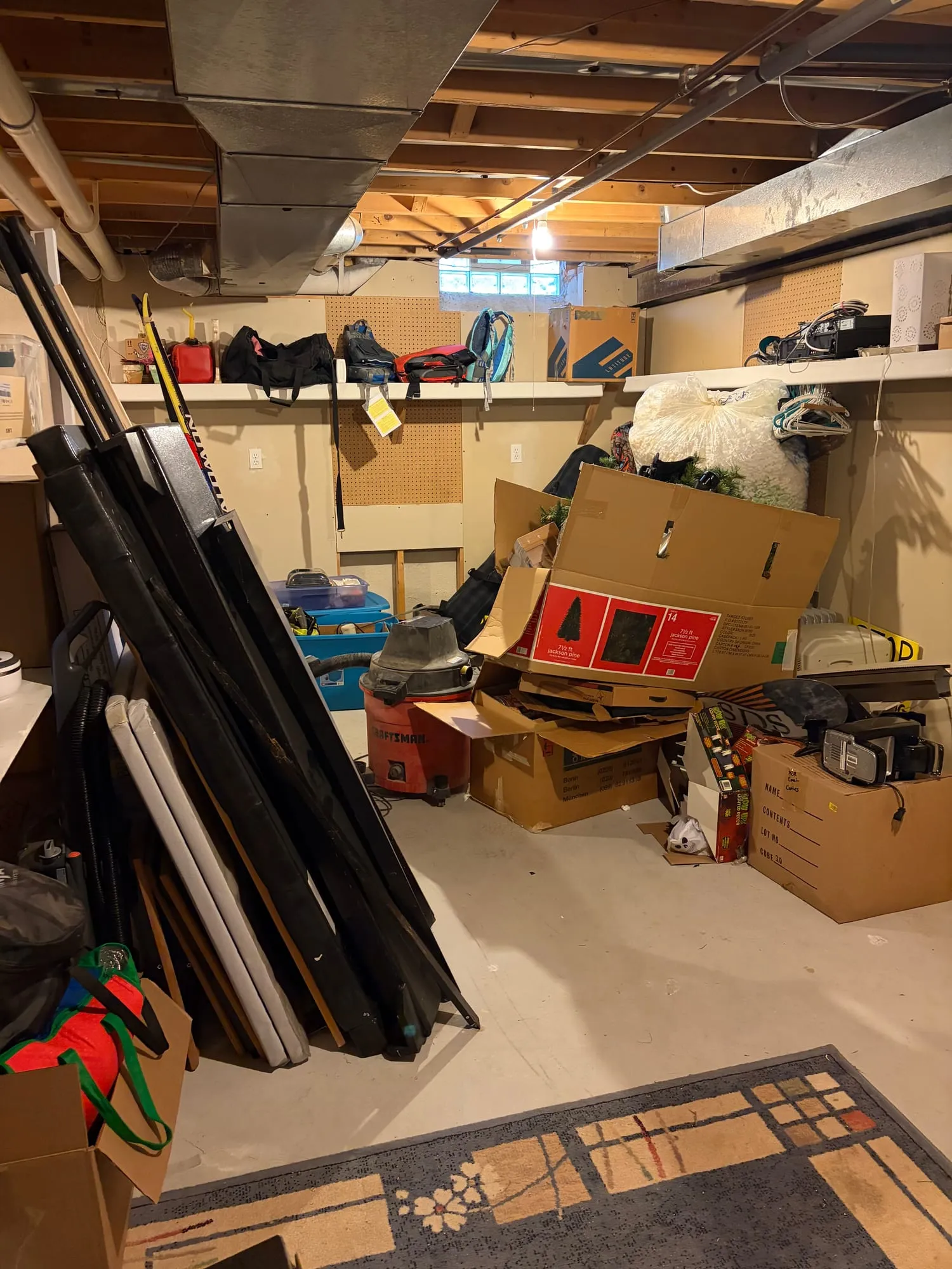 Garage stacked with boxes, framed art and clutter before a cleanout