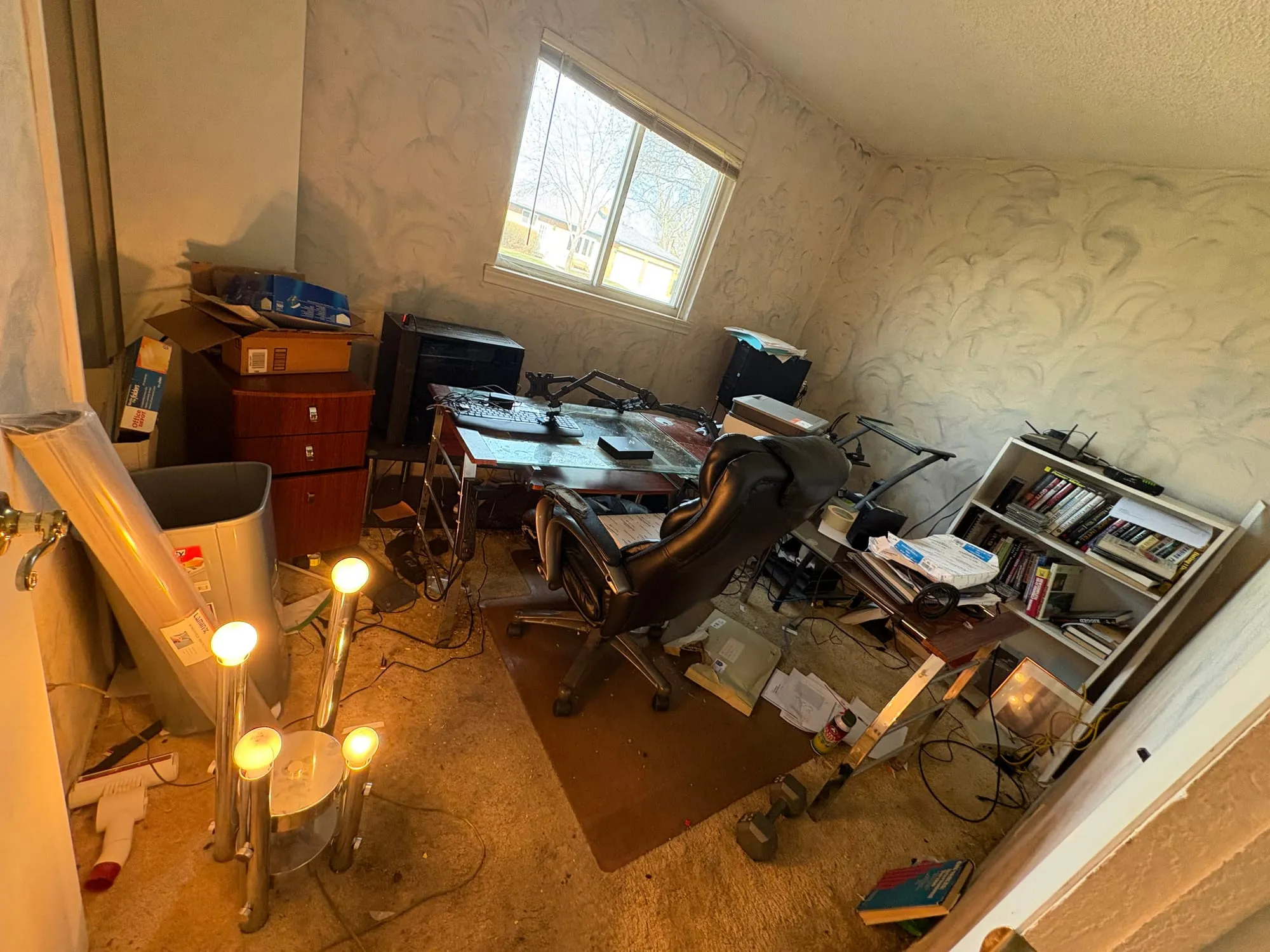 Office room filled with old desks, monitors and chairs before removal