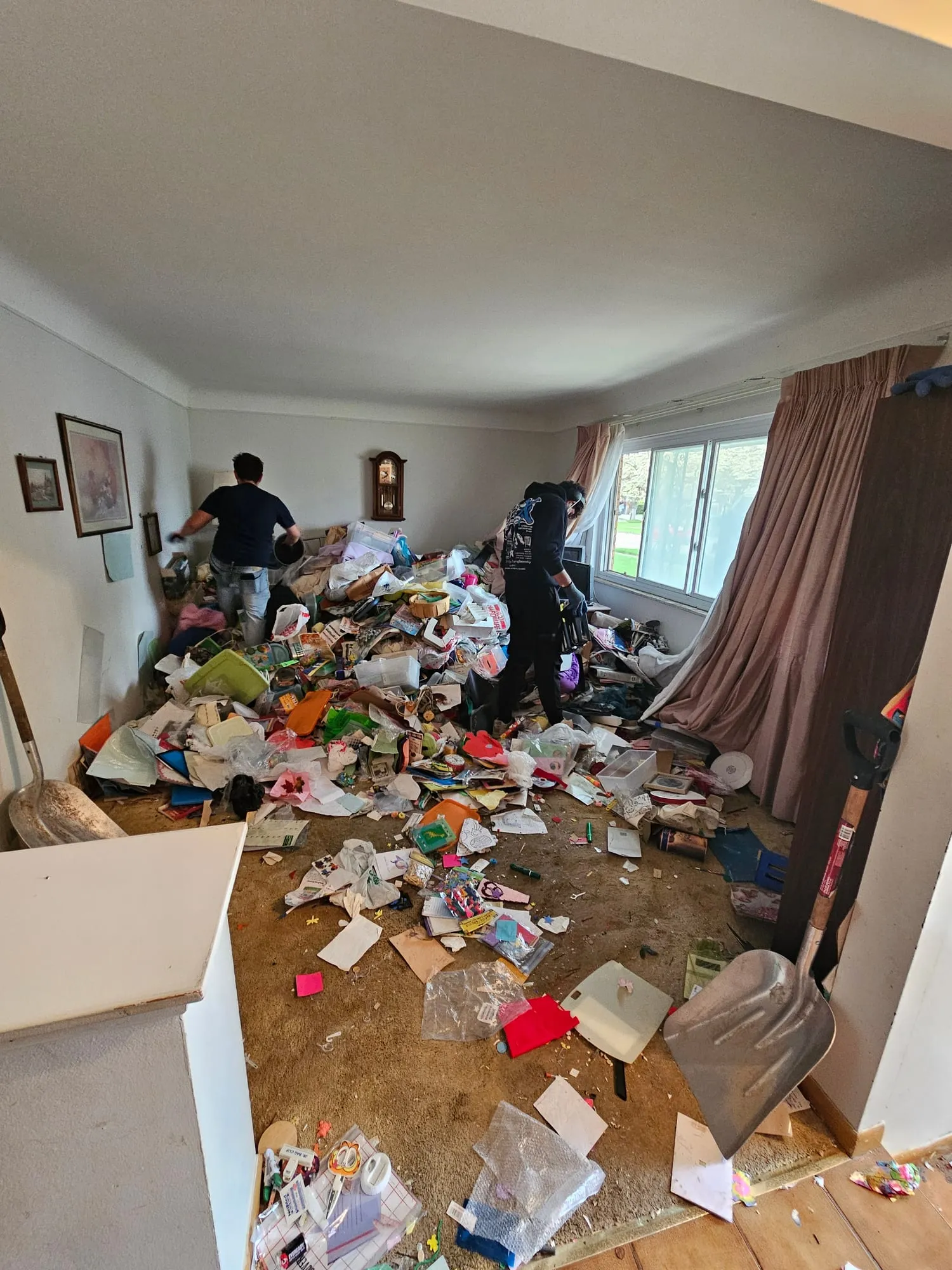 Penguin Junk Removal crew clearing a tenant turnover unit full of debris