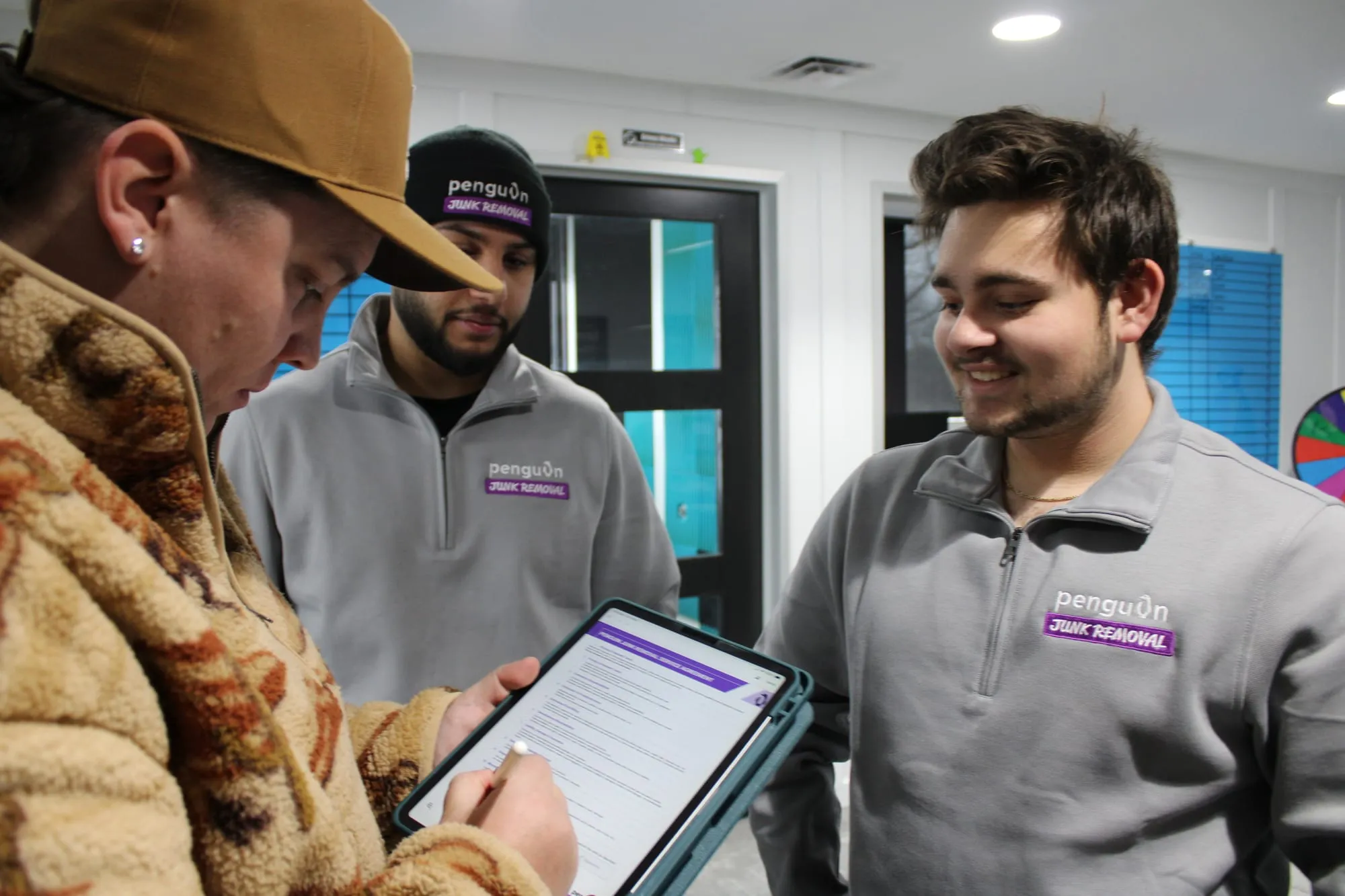Penguin Junk Removal team going over a job quote on a tablet